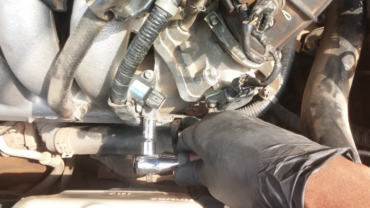 Removing bracket holding the +ve battery cable to the intake manifold